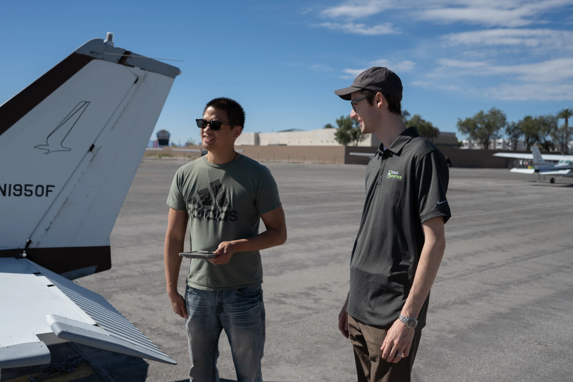 Vegas Aviation instructor and student beside aircraft tail